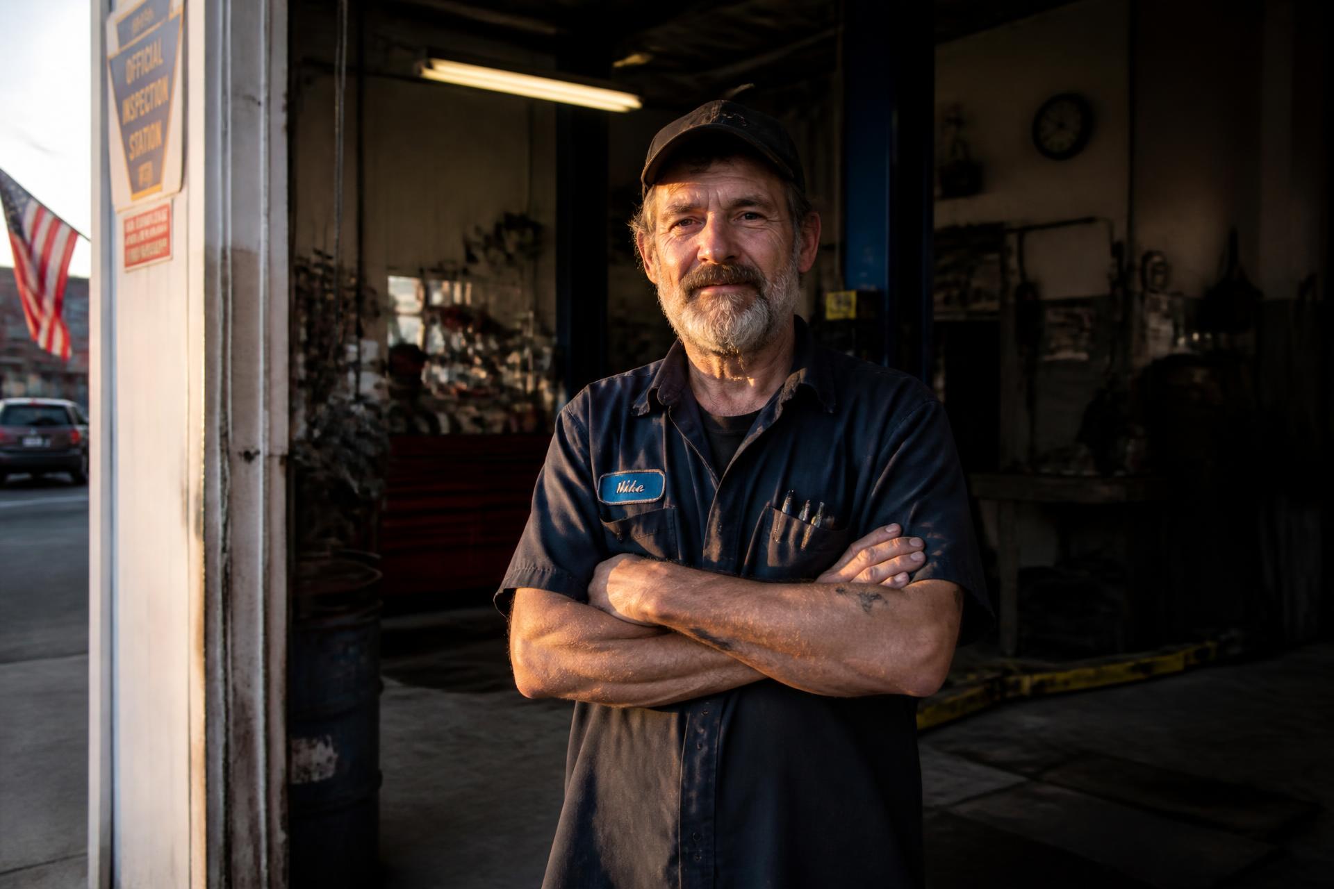 A business owner standing in the open bay of his shop in Northeast Connecticut